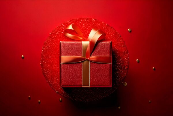 a red background with a singular gift in the center for the TEDxPacificPalisades