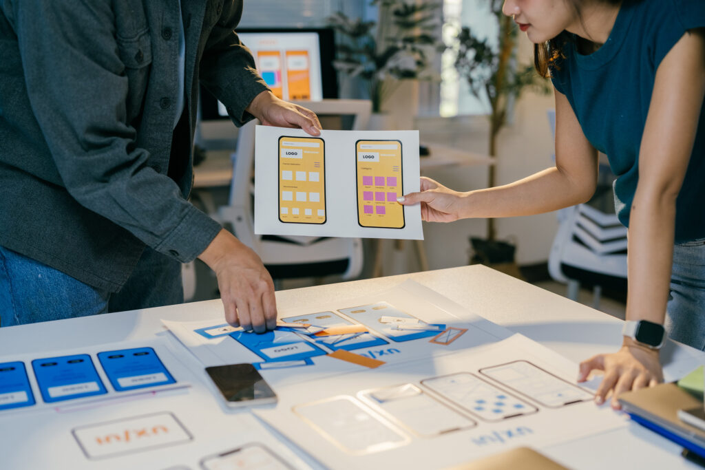 web designers reviewing layouts of mobile